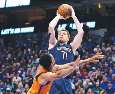  ?? Associated Press ?? Phoenix Suns guard Cameron Payne defends as Dallas Mavericks guard Luka Doncic (77) takes a shot in the second half of Game 4 of an NBA basketball second-round playoff series Sunday in Dallas.
