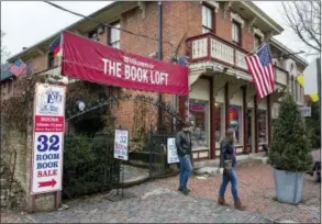  ??  ?? Customers depart the entrance path at The Book Loft of German Village in Columbus, Ohio. The 40-year-old bookstore features 32 rooms of books. 631 S. Third St., Columbus, Ohio; http://www.bookloft.com/ or 614-464-1774. Open daily 10 a.m.-11 p.m.