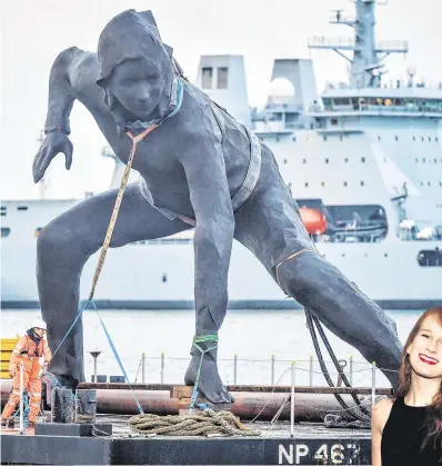  ??  ?? Arrival: The giant statue made the final leg of its journey by barge across Plymouth Sound. Below, actress Nicola Kavanagh, whose pose inspired the work