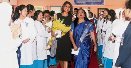  ??  ?? Students lined the school compound to say goodbye to Nirmala who was accompanie­d by her daughter Natasha Chandran (in black).