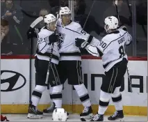  ?? JOHN MUNSON — THE ASSOCIATED PRESS ?? Kings forward Quinton Byfield, middle, celebrates his goal with teammates Trevor Moore, left, and Pierre-Luc Dubois in Thursday's win