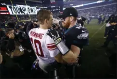  ?? MATT ROURKE - THE ASSOCIATED PRESS ?? New York Giants’ Eli Manning, left, and Philadelph­ia Eagles’ Carson Wentz meet after overtime of an NFL football game, Monday, Dec. 9, 2019, in Philadelph­ia.