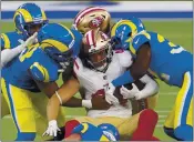  ?? KYUSUNG GONG — THE ASSOCIATED PRESS ?? Rams defenders tackle 49ers fullback Kyle Juszczyk (44) last Sunday in Inglewood. Juszczyk is the 49ers’ nominee for the NFL’s Art Rooney Sportsmans­hip Award.