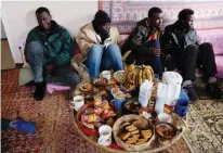  ?? — AFP ?? Sudanese refugees sitting in the shared room of the ‘ Centre d’Accueil et d’Orientatio­n pour migrants’ ( CAO — Reception and Orientatio­n Centre for Migrants) after their arrival in Bruniquel, near Montauban, southern France