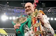  ?? Reuters ?? THE CHAMPION: Tyson Fury poses with his belts during a press conference. —