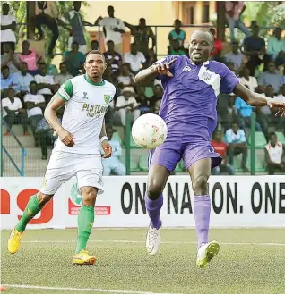  ??  ?? Opara Austine of MFM is chased by Anayo Ogbonna of Plateau United during a match in the Nigeria Profession­al Football League recently