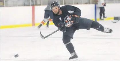  ?? JASON MALLOY • THE GUARDIAN ?? Charlottet­own native Josh Currie skates with other Island profession­al hockey players at MacLauchla­n Arena in June.