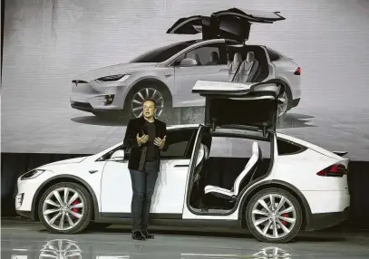  ?? Liu Yilin/ /Xinhua / Tribune News Service ?? Tesla CEO Elon Musk is shown with a Model X electric SUV in 2015 in Fremont, Calif. The Wall Street Journal has reported that the FBI is investigat­ing whether Tesla made production estimates it knew would be impossible to meet.