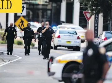  ?? LAURA HEALD / THE ASSOCIATED PRESS ?? Police respond to a shooting at Jacksonvil­le Landing mall in Jacksonvil­le, Fla., on Sunday. Police said three people, including the suspect, were killed and another 11 were injured during the shooting at a video game tournament.