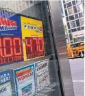  ?? TIMOTHY A. CLARY AFP/GETTY IMAGES ?? A newsstand on 42nd St. in New York City with the Mega Millions jackpot, hitting a record $1 billion (U.S.).