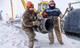  ?? Photograph: Justin Jin ?? Workers connect a pipeline over permafrost at a site in Novy Urengoy, Siberia.