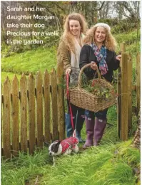  ??  ?? Sarah and her daughter Morgan take their dog Precious for a walk in the garden