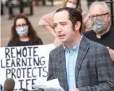  ??  ?? James Cahill, a teacher at St. Francis Xavier in Wilmette, speaks outside the offices of the Archdioces­e of Chicago demanding that the archdioces­e go to fully remote learning. TYLER LARIVIERE/SUN-TIMES