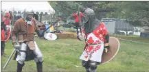  ??  ?? Bjorn (John Hodson) spars with Baron Harald Brandarm (John McLaughlin) at the Barrony of Dun Carraig, a chapter of the Society for Creative Anachronis­m, which met on the grounds of the College of Southern Maryland April 22.