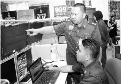  ??  ?? Jemros inspecting a monitor at the fire and rescue operation centre at the Lintas headquarte­rs yesterday.