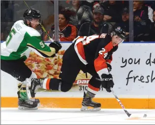  ?? NEWS PHOTO RYAN MCCRACKEN ?? Medicine Hat Tigers winger Josh Williams shakes off a hit from Prince Albert Raiders Zack Hayes during a Western Hockey League game at the Canalta Centre on Oct. 7, 2017.