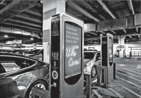  ?? BRIAN CASSELLA/CHICAGO TRIBUNE ?? The U.S. Department of Energy’s alternativ­e fuels website says there are 24,409 electric vehicle charging stations in the U.S., including 563 in Illinois. Electric vehicle charging stations, above, are available in a parking garage at NewCity in Chicago.