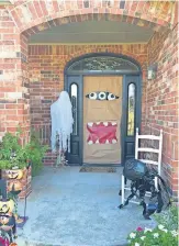  ??  ?? Above: The front door is decked for the season, but Brenda Woodard says the light will be off this Halloween because of the coronaviru­s. [SUBMITTED /BRENDA WOODARD] RIght: This home on Sonora Lane in Norman looks inviting for Halloween. [SUBMITTED / ERIN YARBROUGH]