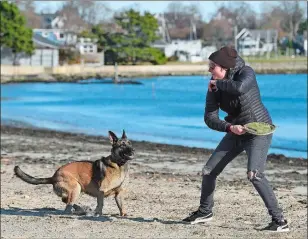  ?? SARAH GORDON/THE DAY ?? Courtney Wilson of Mystic plays with her dog Ezra at Esker Point Beach in Groton on Wednesday.