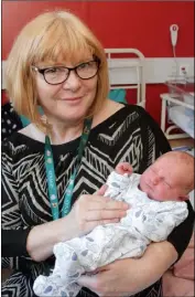  ??  ?? Baby Finn Allis with midwife Bernadette Honohan.