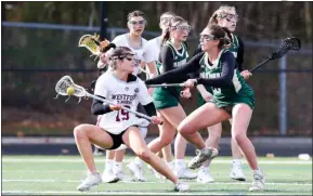  ?? JAMES THOMAS PHOTO ?? Westford’s Kassidy Carmichael changes direction as she is defended by Caroline Pinto of Nashoba Regional during WA’S 18-10girls lacrosse win Friday.