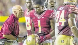  ?? MARK WALLHEISER/AP FILE ?? Florida State defensive coordinato­r Charles Kelly, left, has faced much criticism for the Seminoles’ 1-3 start to the season.