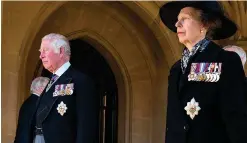  ??  ?? The Prince of Wales and the Princess Royal follow the Land Rover Defender