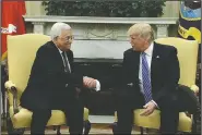  ?? AP/EVAN VUCCI ?? Palestinia­n leader Mahmoud Abbas and President Donald Trump meet Wednesday at the White House, where Trump committed to helping the Israelis and Palestinia­ns reach a peace agreement.