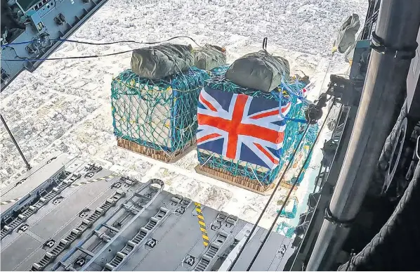  ?? ?? The Royal Air Force sends an aid package containing water, rice, cooking oil, flour, tinned goods and baby formula into the Gaza strip. The RAF dropped over 10 tons of supplies on Monday in its first delivery