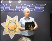  ?? ?? Former Chico police Lt. Linda Dye holds up three badges Thursday at the Chico Fire Training Center in Chico. The badges replace three that she lost in the 2018Camp Fire.