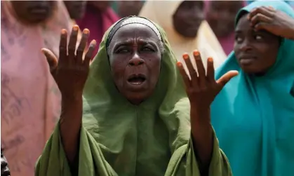  ?? ?? A woman prays for the kidnapped pupils in Kuriga, Kaduna state. Photograph: Sunday Alamba/AP