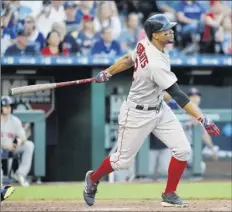  ?? Charlie Riedel / Associated Press ?? Xander Bogaerts of the Red Sox hits a three-run double during the fifth inning against the Royals on Saturday.