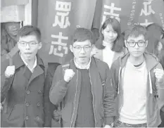  ?? AGENCE FRANCE PRESSE ?? Bailed Hong Kong democracy activists (from left) Joshua Wong, Nathan Law and Alex Chow face the media outside the Court of Final Appeal before their first appeal hearing against jail sentences in Hong Kong.