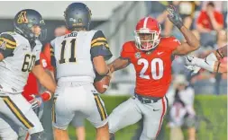  ?? JOHN KELLEY/GEORGIA PHOTO ?? Georgia defensive back J.R. Reed closes in on Appalachia­n State quarterbac­k Taylor Lamb during last Saturday’s 31-10 win by the Bulldogs.