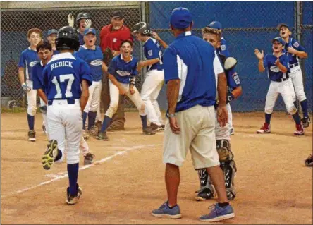  ?? STAN HUDY - SHUDY@DIGITALFIR­STMEDIA.COM ?? Saratoga Springs Little League’s Owen Redick gets a hero’s welcome after hitting a walk-off grand slam in Monday’s District 11⁄12 championsh­ip finale against Rotterdam/Carman.