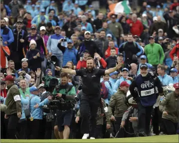  ?? MATT DUNHAM — THE ASSOCIATED PRESS ?? Ireland’s Shane Lowry soaks up the adulation on the 18th green of the British Open. He earned his first major win.