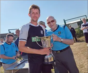  ??  ?? Jim McLaughlin presents Neilly Martin with the Jim McLaughlin Premier Trophy.