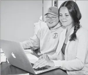  ?? JEREMY FRASER/CAPE BRETON POST ?? Sara McMahon, right, and Brendan O’Grady look at the list of events for this year’s Bartown Days Festival in North Sydney. The 44th annual festival will begin on Saturday and will feature several new events this year.