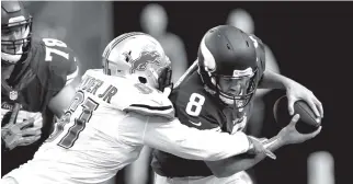  ?? THE ASSOCIATED PRESS ?? Minnesota Vikings quarterbac­k Sam Bradford (8) is sacked by Detroit Lions defensive end Kerry Hyder, left, during the second half of their game Sunday in Minneapoli­s.