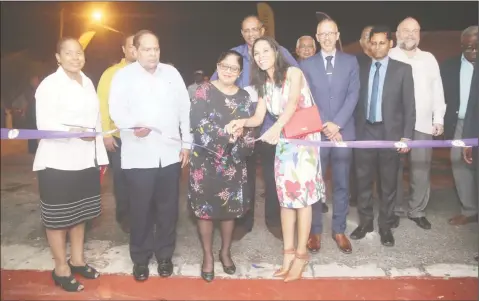  ?? (Photo by Keno George) ?? Han Gaskin (front right), wife of Minister of Business Dominic Gaskin (fourth from right) and Sita Nagamootoo, wife of Prime Minister Moses Nagamootoo (second from left) cut the ribbon last evening to mark the opening of Guyanese Flavour UNCAPPED.