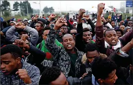  ??  ?? Hands aloft: The crowd protests against the camp’s demolition