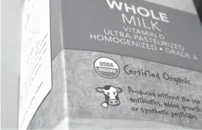  ?? Associated
Press ?? ABOVE:
A “USDA Organic”
label is printed on a milk carton on July 9 in Walpole,
Mass. The USDA Organic label generally signifies a product is made without synthetic pesticides and fertilizer­s, and that animals
are raised according to certain...