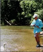  ?? Arkansas Democrat-Gazette/BRYAN HENDRICKS ?? Ray Tucker of Little Rock battles a smallmouth bass on a wade fishing outing in the Ouachita Mountains.