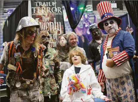  ?? Trish Haldin / For Hearst Connecticu­t Media file photo ?? Peyton Vesneski, 12, with a group of ghoulish creatures at the Connecticu­t HorrorFest.