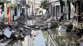  ?? OLIVER BERG AP ?? Water stands in the town center in Bad Muensterei­fel, western Germany, Sunday, after heavy rains caused mudslides and flooding.