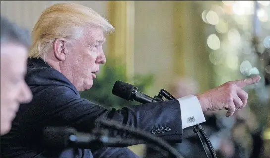  ?? [ANDREW HARNIK/THE ASSOCIATED PRESS] ?? President Donald Trump, accompanie­d by Colombian President Juan Manuel Santos, left, calls on a reporter during a news conference Thursday in the East Room of the White House.