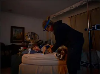  ?? RJ SANGOSTI — THE DENVER POST ?? Amy Wiedeman gets her 12-year-old son Luke Schiller ready for bed at their home in Centennial on Jan. 31. Colorado’s Medicaid agency is asking for more money for people who provide home care services for people like Luke, who has cerebral palsy and other illnesses that require around-the-clock care. Wiedeman said they’ve never been able to hire all the help Luke qualifies for, so she and her ex-husband take “night shifts” making sure Luke doesn’t choke or have a seizure.