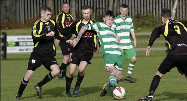  ??  ?? Shane Walker of Arklow Celtic is surrounded by Arklow United trio Karl Kirwan, Jonny Quinn and David O’Neill.