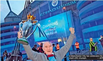  ?? — AFP ?? A Manchester City fan celebrates his club’s EPL triumph.