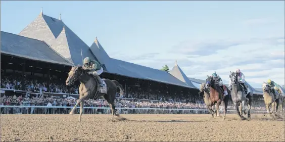  ?? Photos by Skip Dickstein / Special to the Times Union ?? Although a packed crowd saw Code of Honor capture the 150th Travers Stakes last year, the Saratoga grandstand­s will be empty for the 2020 race.